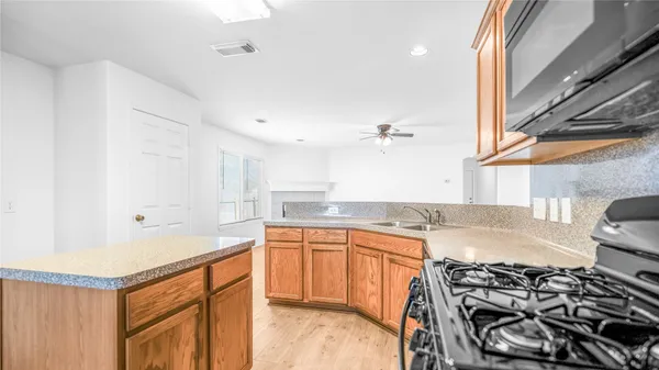 a kitchen with a sink stove and cabinets