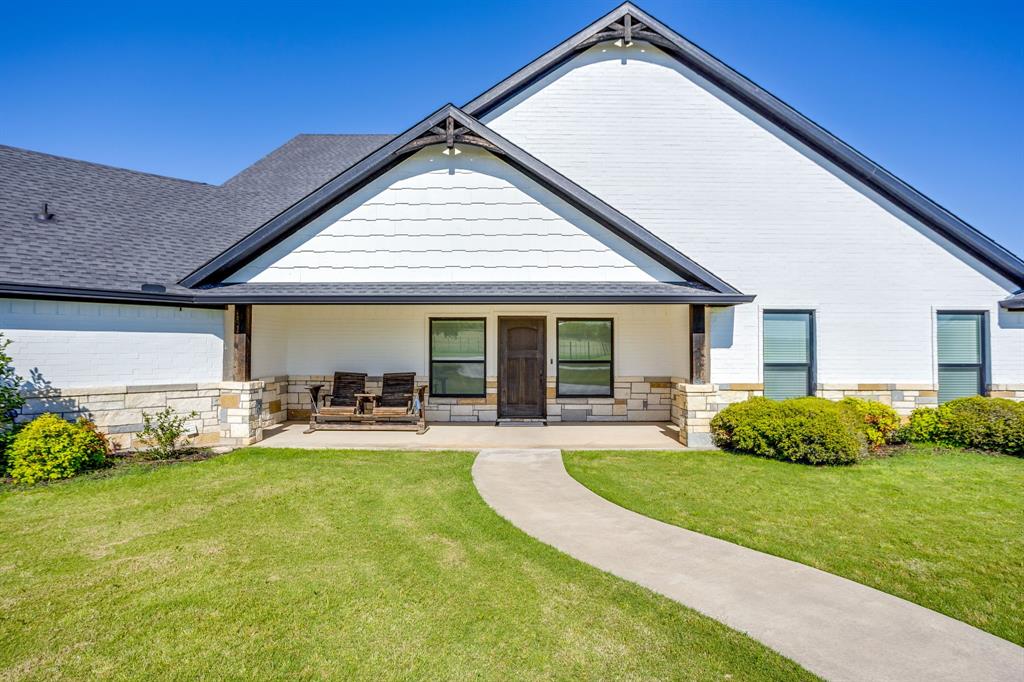 733 Fm 2652 Graham, TX 76450 - Photo 2 of 40 a front view of a house with a yard and porch