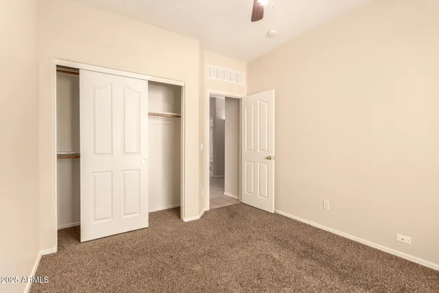 a view of an empty room with closet area