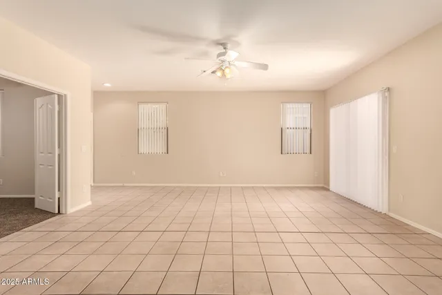an empty room with windows and white walls