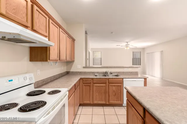 a kitchen with a sink stove top oven and cabinets