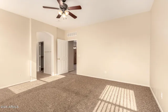 a view of a hallway with a chandelier fan