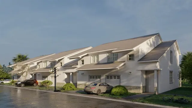 a front view of a building with lots of green space