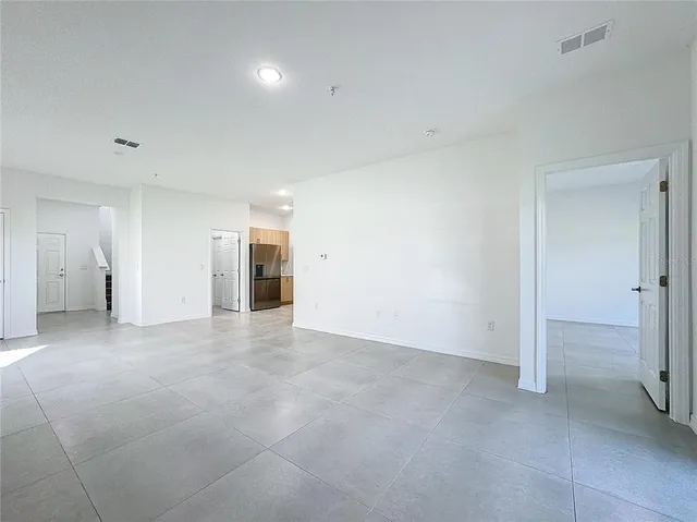 an empty room with windows and closet