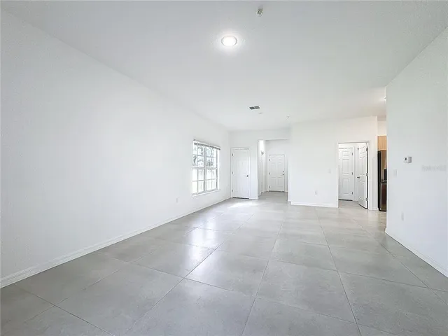 a view of a big room with windows and closet