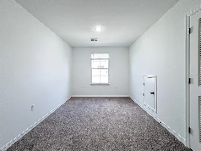 an empty room with a view of bathroom