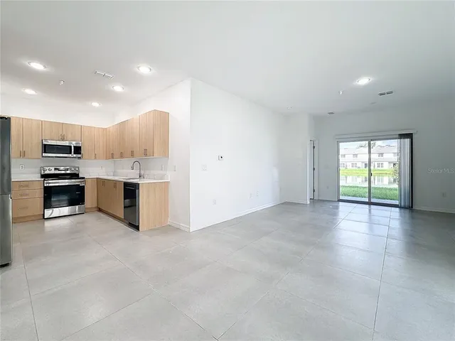 a kitchen with a refrigerator and a sink