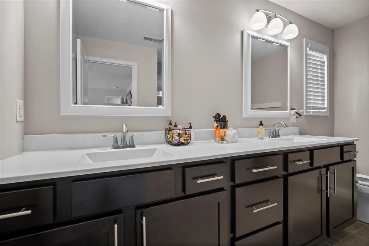 2321 Corrigan Way Normal, IL 61761 - Photo 22 of 33 a bathroom with a double vanity sink and a mirror