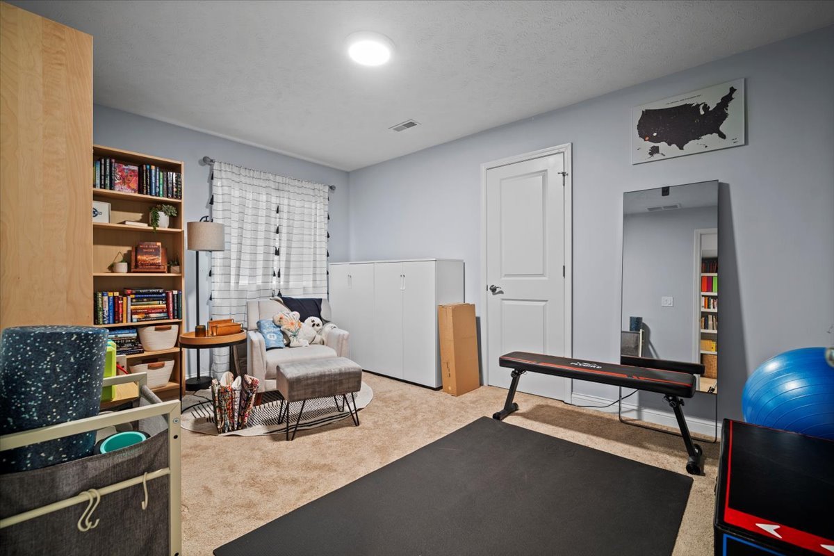2321 Corrigan Way Normal, IL 61761 - Photo 25 of 33 a living room with furniture and a book shelf