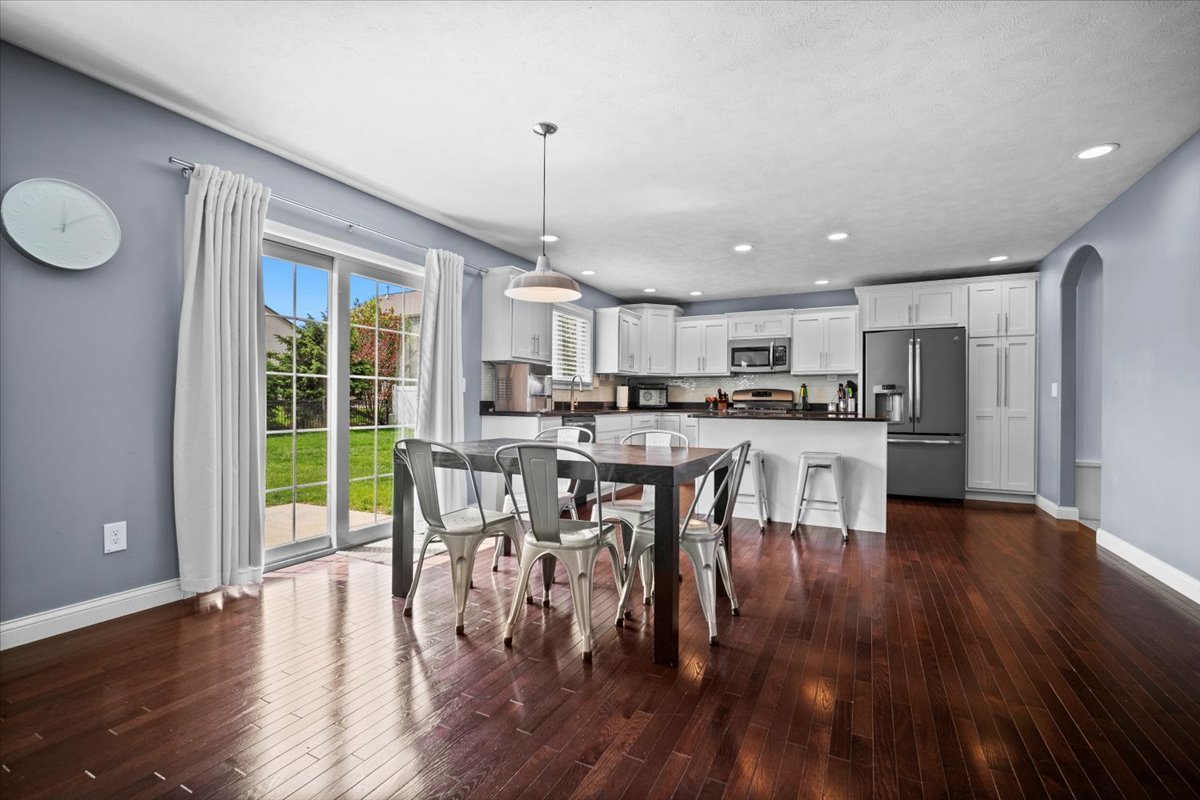 2321 Corrigan Way Normal, IL 61761 - Photo 8 of 33 a kitchen with stainless steel appliances a dining table chairs stove and wooden floor