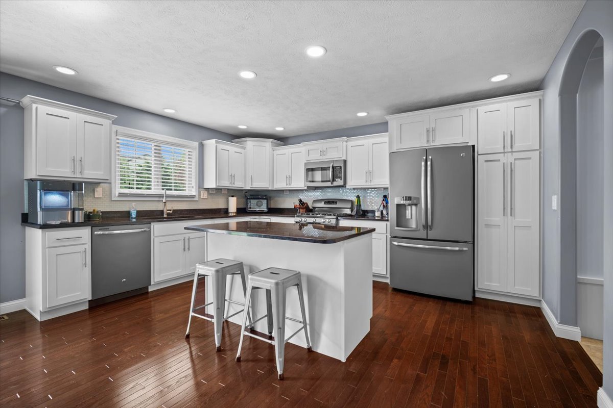 2321 Corrigan Way Normal, IL 61761 - Photo 10 of 33 a kitchen with a refrigerator a sink dishwasher a stove and white cabinets with wooden floor