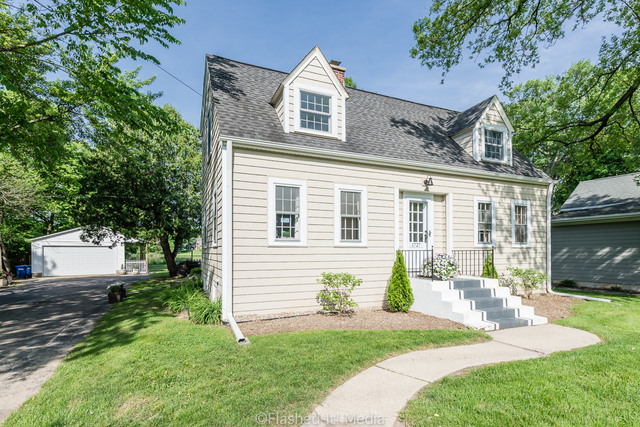 1727 Riverside Avenue St. Charles, IL 60174 - Photo 1 of 50 a front view of a house with a garden and plants