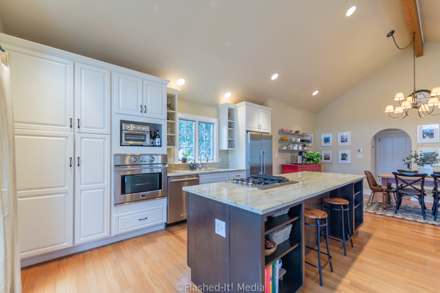 1727 Riverside Avenue St. Charles, IL 60174 - Photo 14 of 50 a kitchen with stainless steel appliances granite countertop a table chairs and a refrigerator