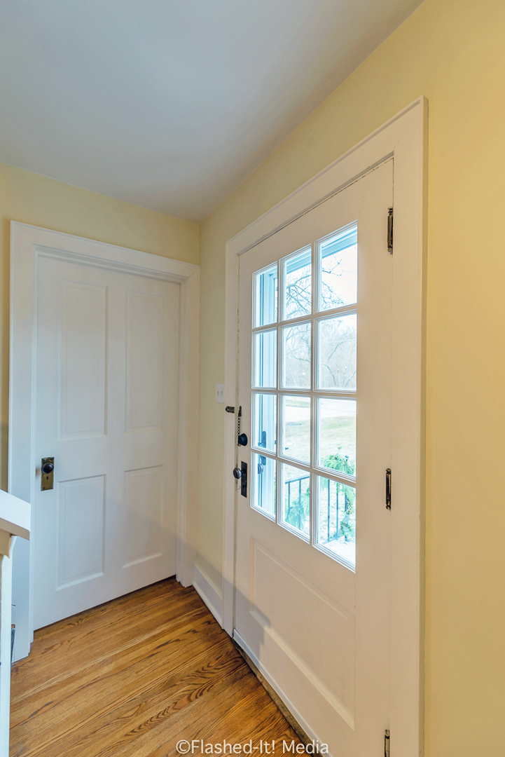 1727 Riverside Avenue St. Charles, IL 60174 - Photo 3 of 50 a view of an empty room with wooden floor and a window