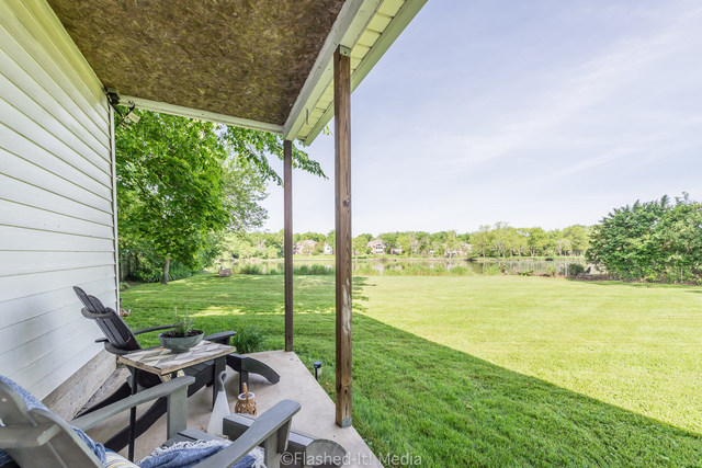 1727 Riverside Avenue St. Charles, IL 60174 - Photo 45 of 50 a view of a patio with lawn chairs under an umbrella