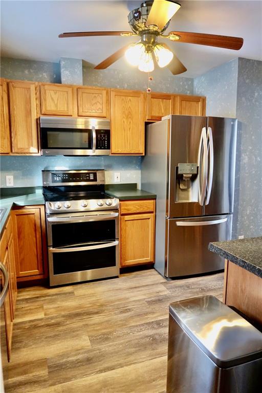 393 Hartwick Road Mercer, PA 16137 - Photo 10 of 50 a kitchen with stainless steel appliances granite countertop a refrigerator a stove and a sink