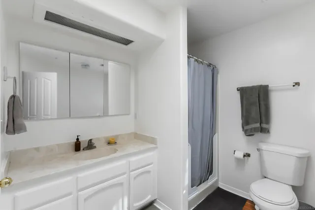 a bathroom with a sink a toilet and mirror