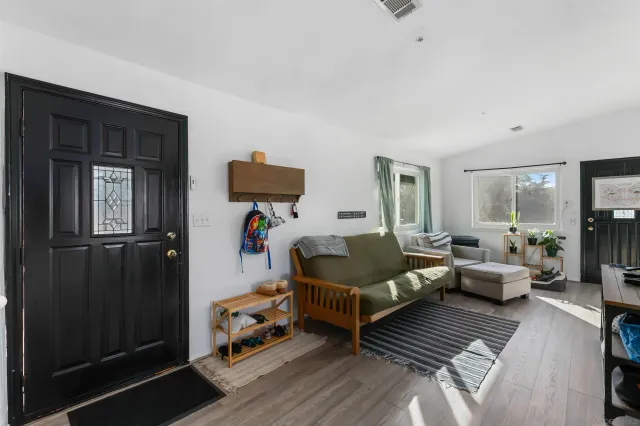 a bedroom with furniture and a rug