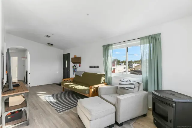 a living room with furniture and a floor to ceiling window