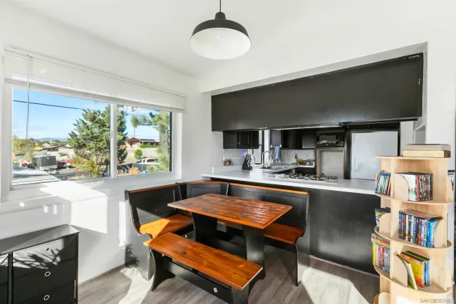 a living room with kitchen island furniture and a flat screen tv
