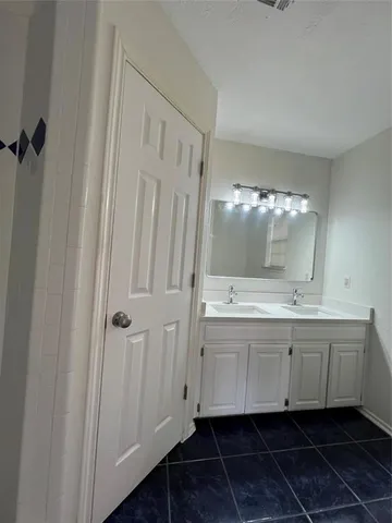 a bathroom with a double vanity sink and mirror