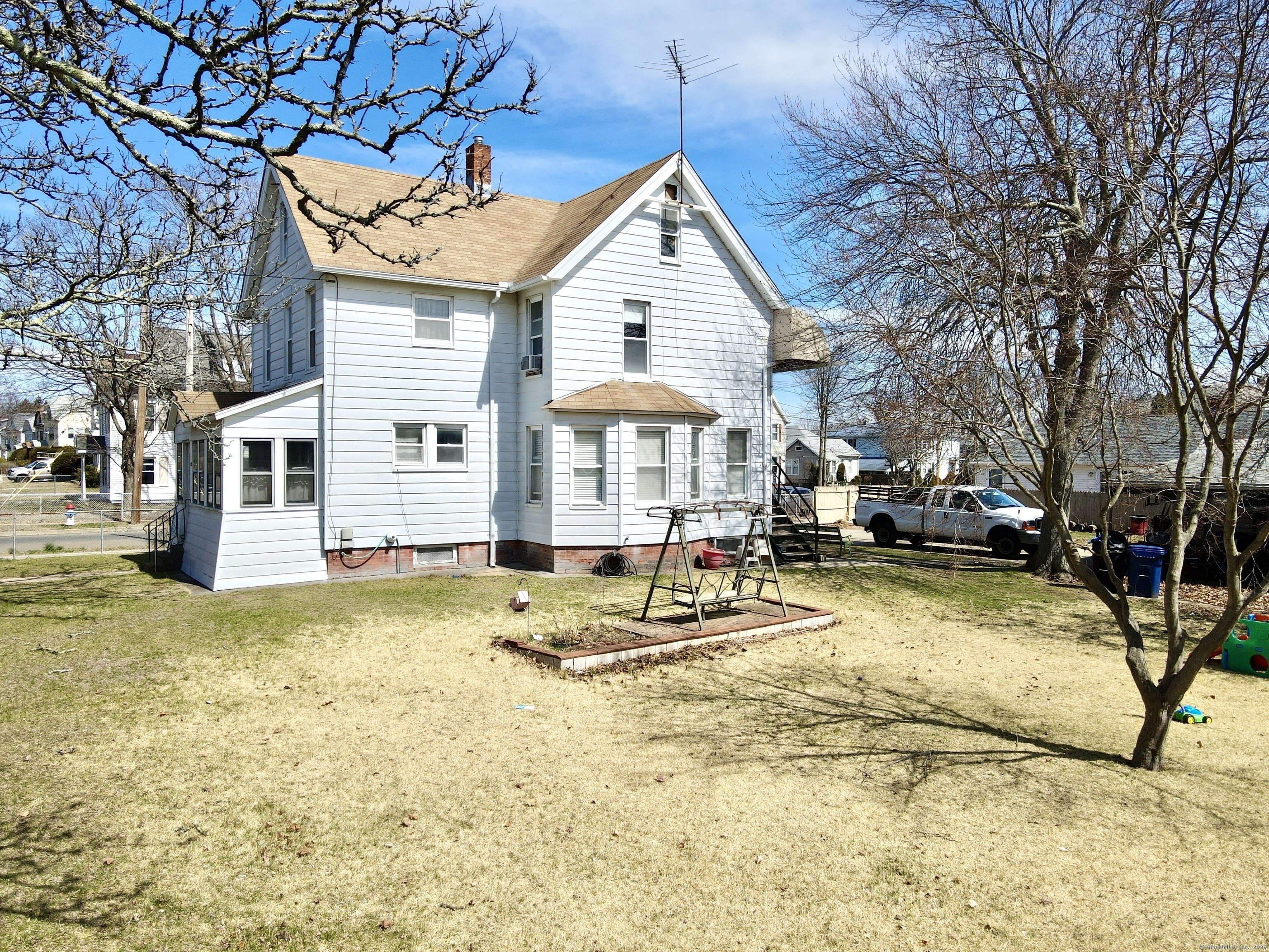 a swimming pool with outdoor seating and yard