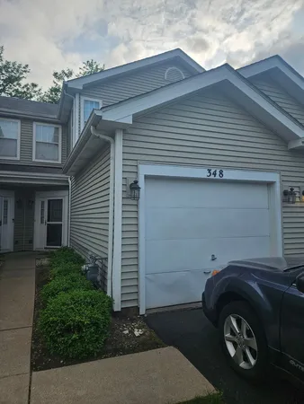 a front view of a house with parking space