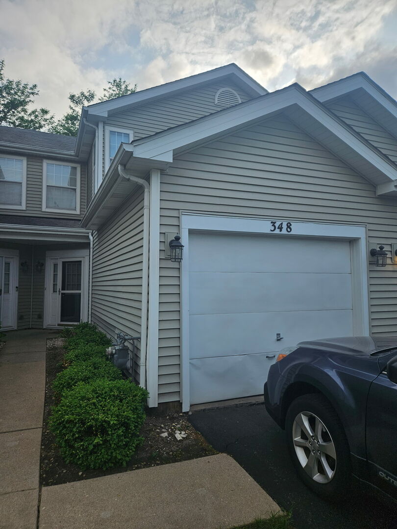 a front view of a house with parking space