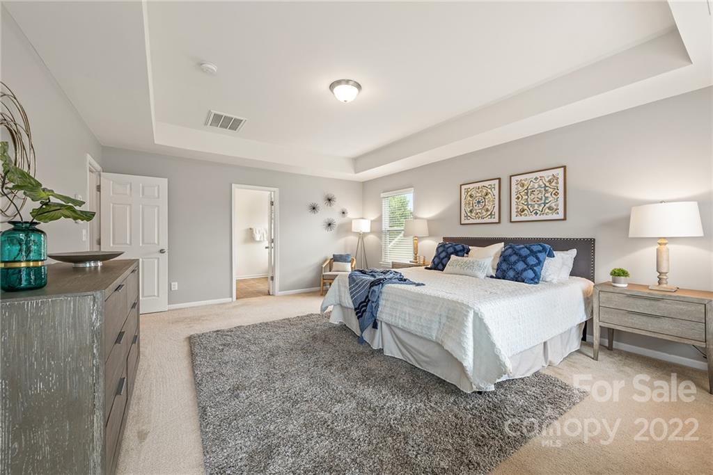 116 Annatto Way Tega Cay, SC 29708 - Photo 20 of 36 a spacious bedroom with a bed and a couch
