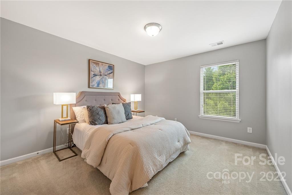 116 Annatto Way Tega Cay, SC 29708 - Photo 24 of 36 a bedroom with a bed and a window