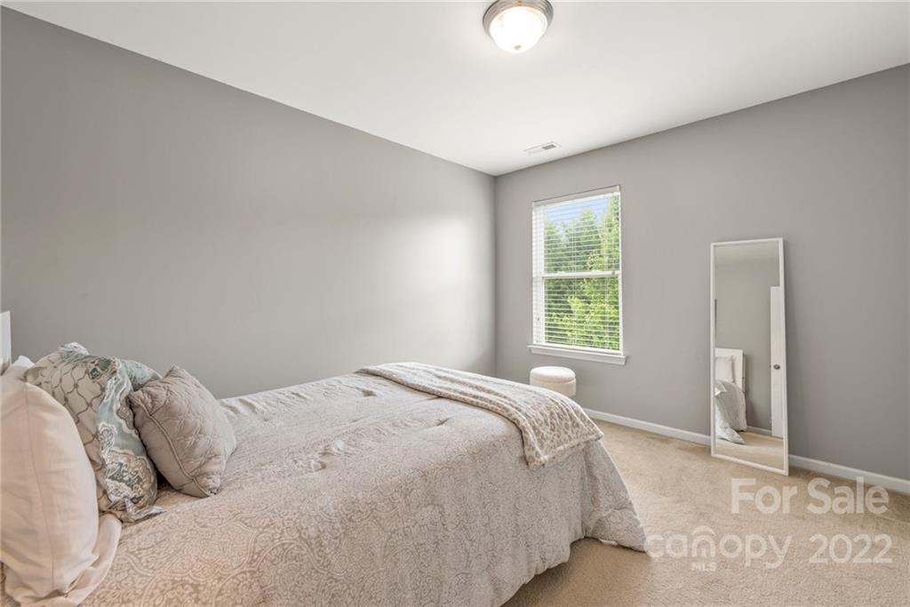 116 Annatto Way Tega Cay, SC 29708 - Photo 25 of 36 a bedroom with a bed and a window