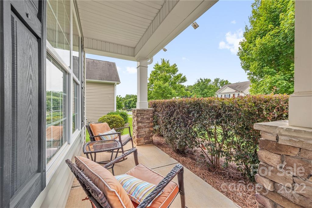 116 Annatto Way Tega Cay, SC 29708 - Photo 27 of 36 a view of a patio with table and chairs and potted plants