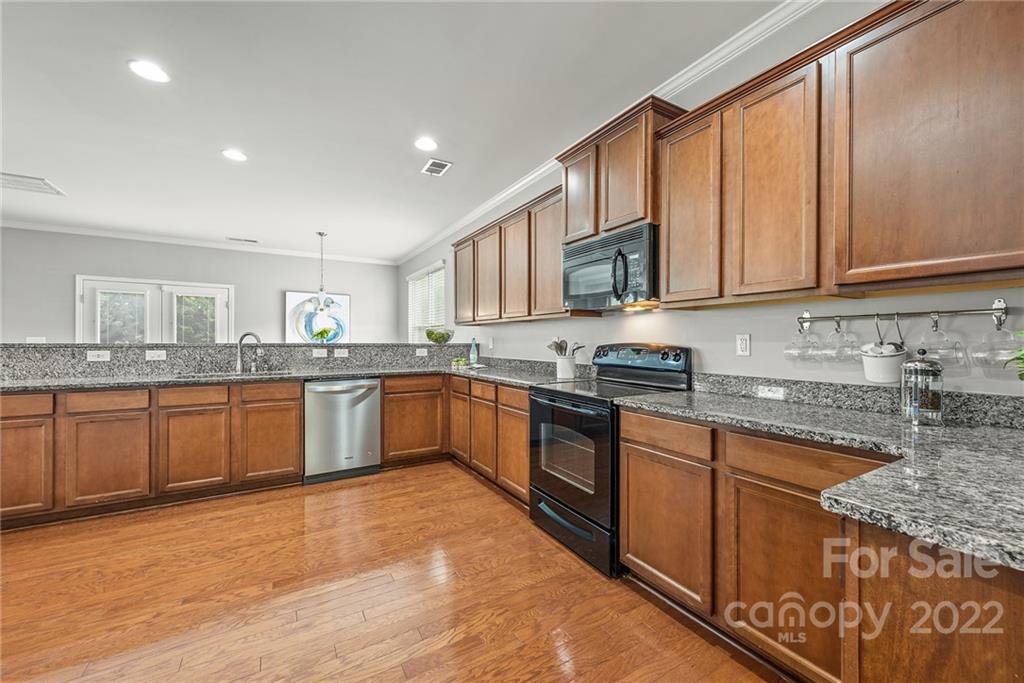 116 Annatto Way Tega Cay, SC 29708 - Photo 8 of 36 a large kitchen with stainless steel appliances granite countertop a stove sink and cabinets