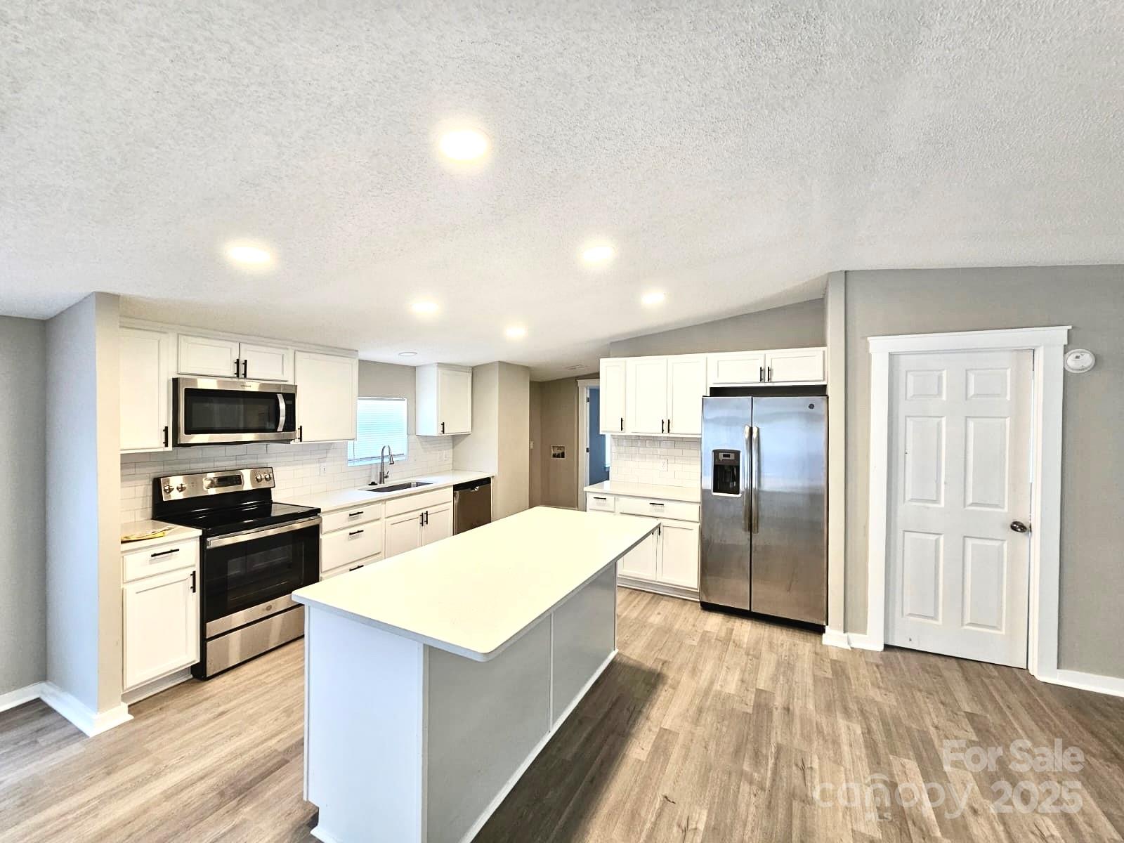 134 Watterson Road Grover, NC 28073 - Photo 2 of 19 a kitchen with refrigerator and cabinets