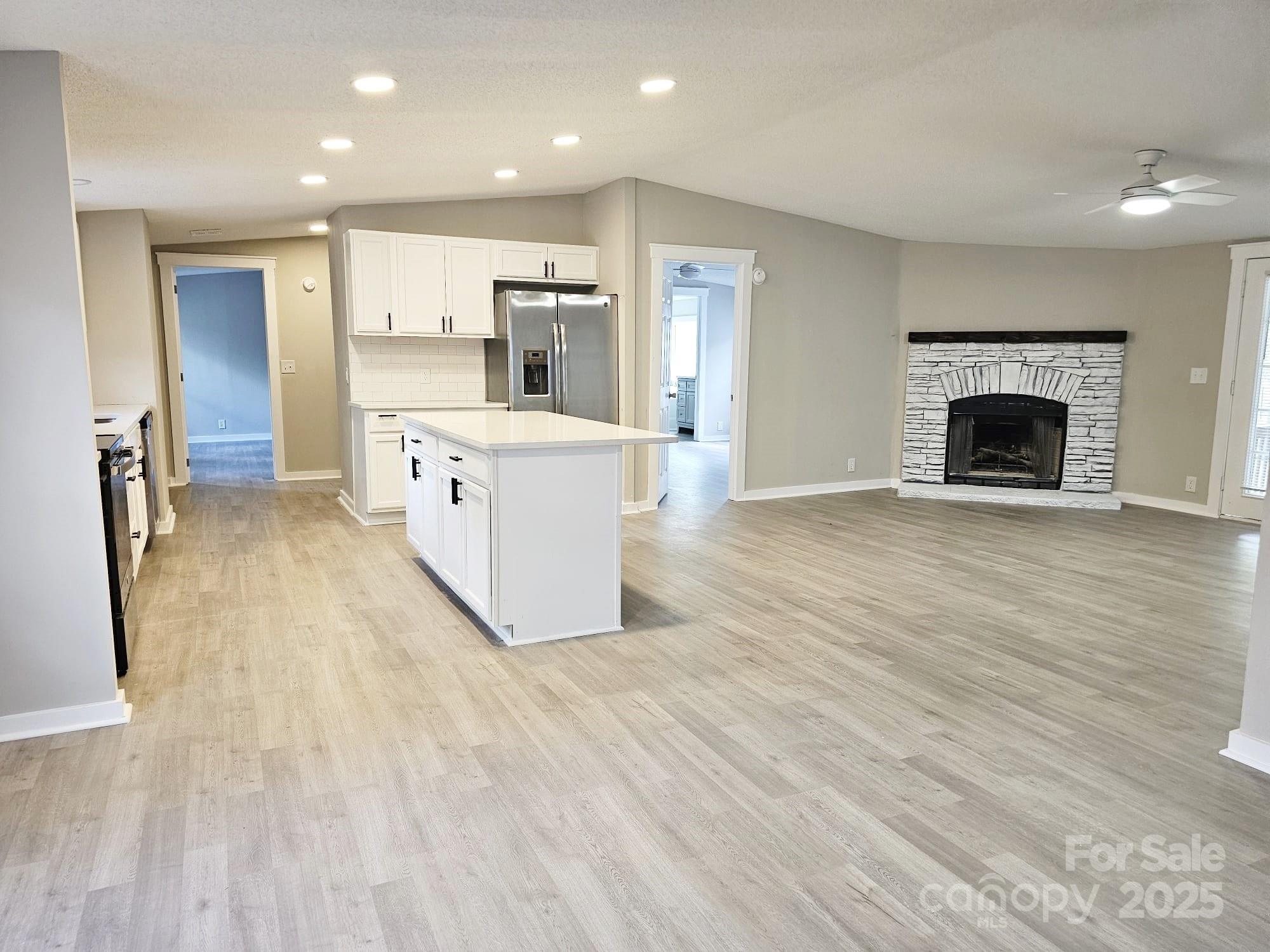 134 Watterson Road Grover, NC 28073 - Photo 3 of 19 a large white kitchen with cabinets a sink and a wooden floor