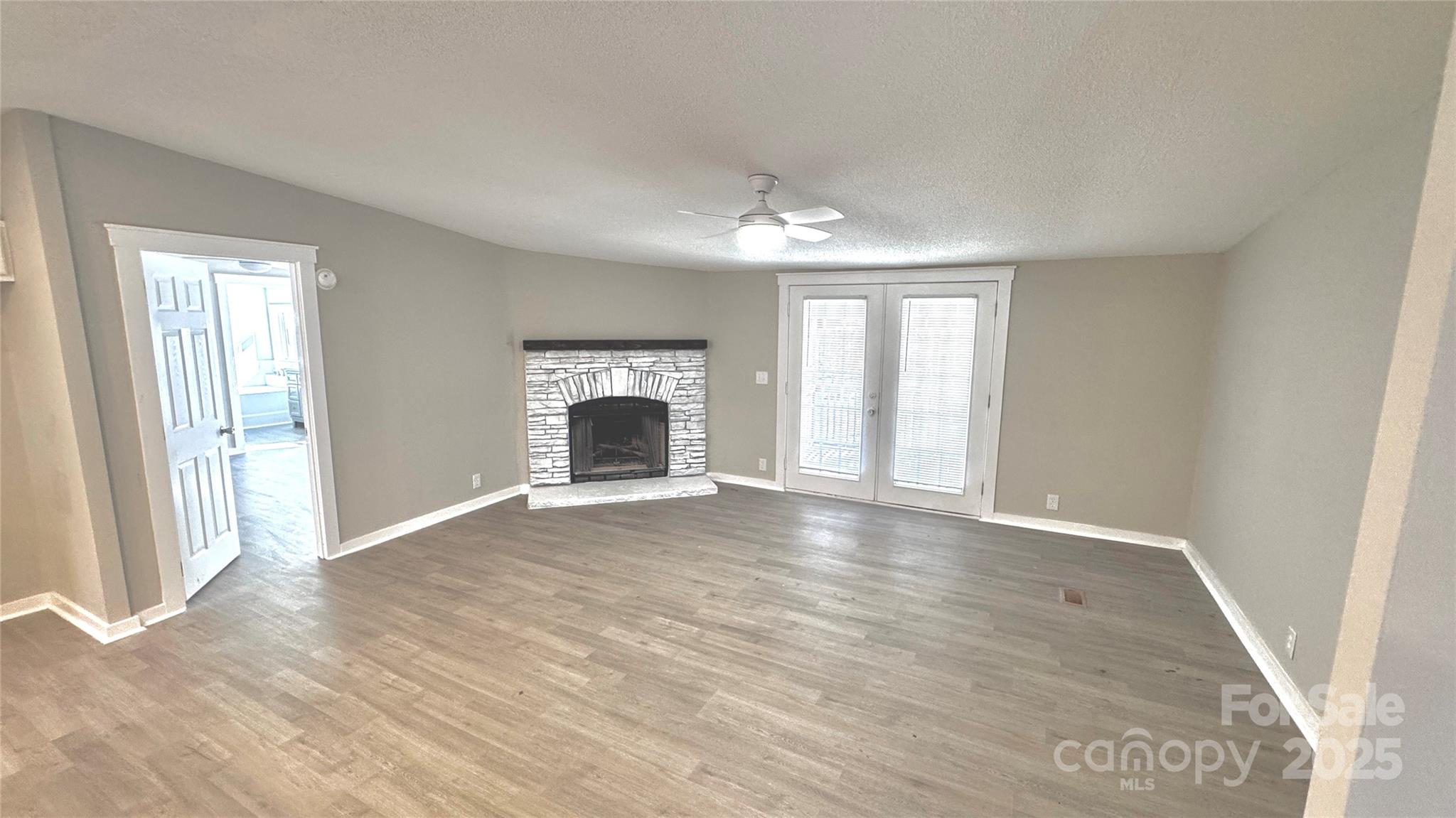134 Watterson Road Grover, NC 28073 - Photo 4 of 19 an empty room with windows and fireplace
