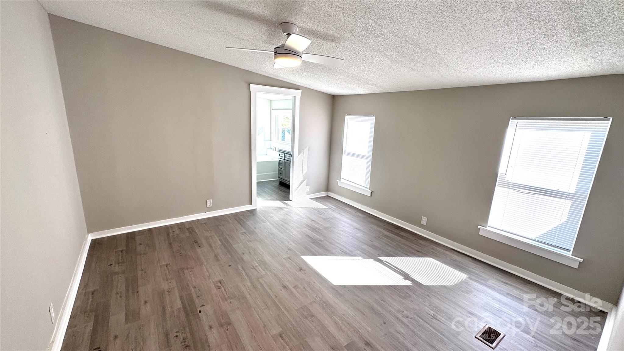 134 Watterson Road Grover, NC 28073 - Photo 6 of 19 an empty room with wooden floor and windows