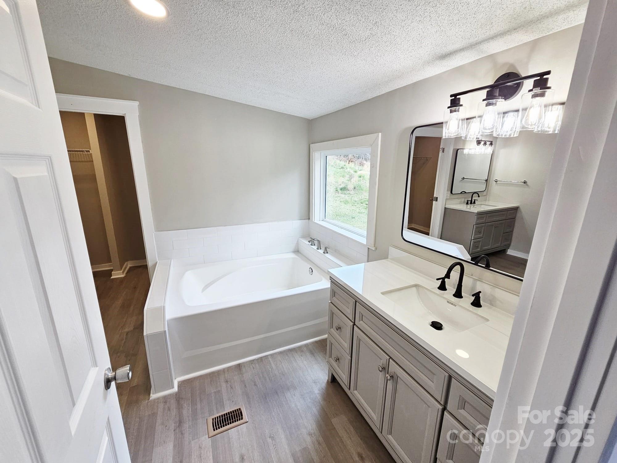 134 Watterson Road Grover, NC 28073 - Photo 7 of 19 a bathroom with a tub sink and mirror