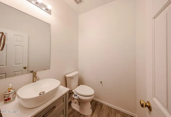 a white toilet sitting next to a bathroom sink