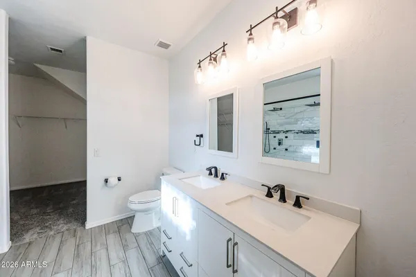 a bathroom with a sink mirror and toilet