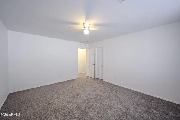 a spacious bathroom with double vanity and a mirror