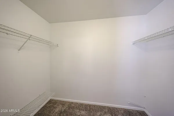 an empty room with a ceiling fan and window