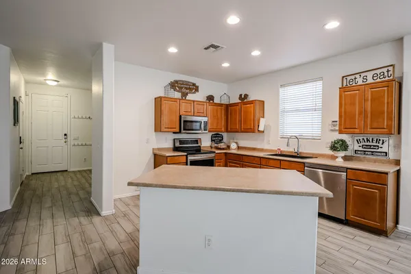a kitchen with wooden cabinets a sink and a stove