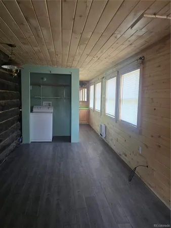 a view of an empty room with a fireplace and a window