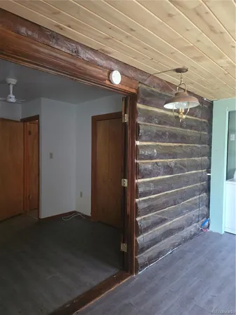an empty room with wooden floor and cabinet