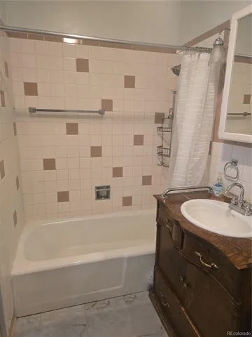 a bathroom with a sink toilet a mirror and shower