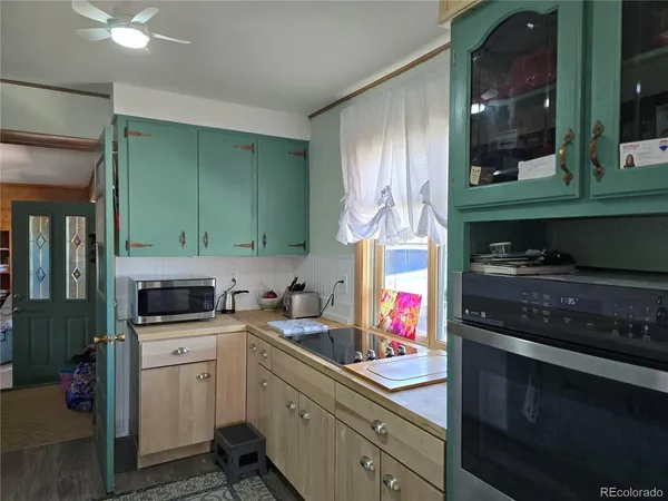 a kitchen with granite countertop a sink cabinets and appliances