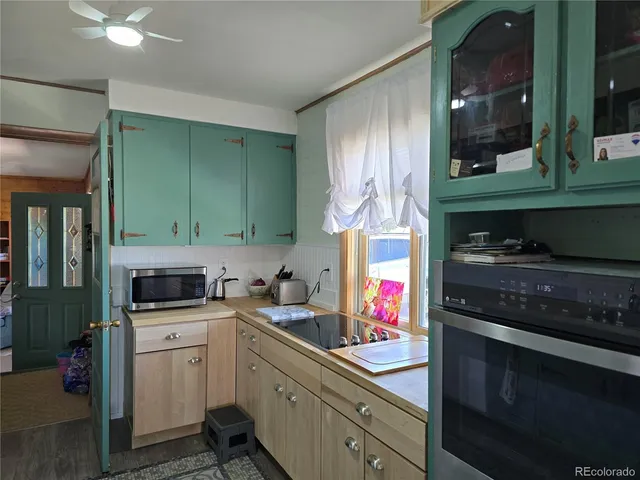 a kitchen with granite countertop a sink cabinets and appliances