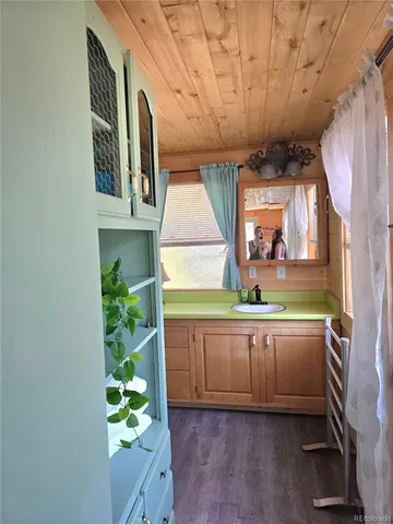 a kitchen with granite countertop white cabinets and window