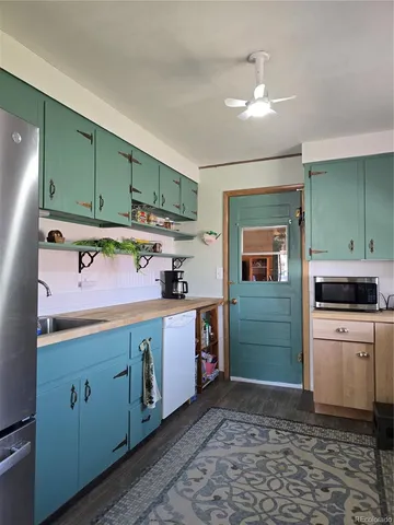 a kitchen with a sink cabinets and appliances